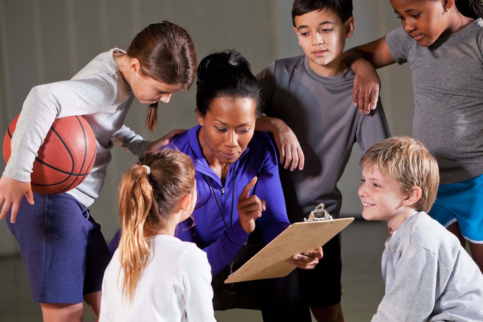 Children with basketball coach